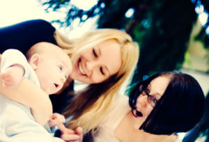 women playing with a baby
