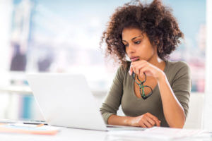 African American woman sitting a a computer