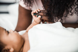 Close up of baby hand holding mommy fingers stock photo