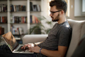 Young man using laptop at home